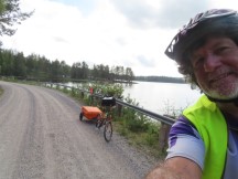 Ted and his bike near lake between Ullånger, Sweden and Bjärtrå, Sweden.