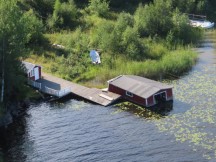 Sinking boathouse on Ångerman River seen from the bridge to Lunde, Sweden.