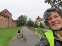Ted with his bike in front of old town's surrounding wall  in Nuremberg, Germany.