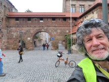 Ted with his bike in front of old town's surrounding wall  in Nuremberg, Germany.