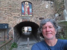 Ted in front of path though building in Rostock, Germany.